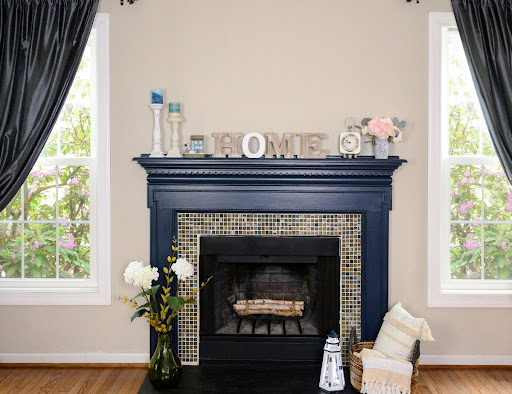 A fireplace is pictured in a living area of a home.